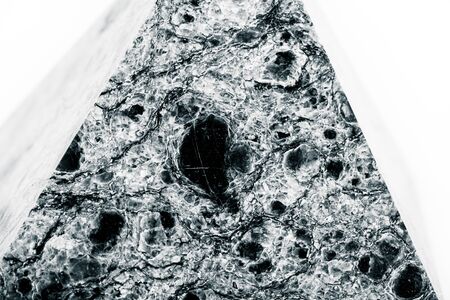 Stone pyramide on a white background. Selective focus. Shallow depth of field. Toned.の写真素材