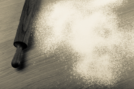 Rolling pin and flour on a light wooden table. Toned.の写真素材