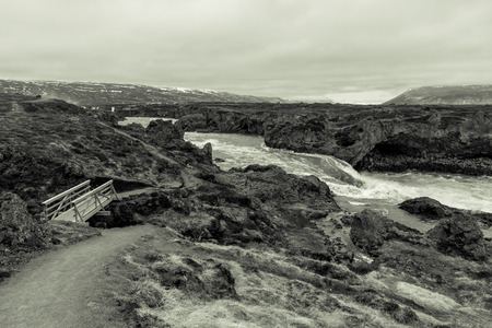 Water of stormy mountain river from waterfall - beautiful part of stony rocky desert landscape of Iceland. Toned.の写真素材