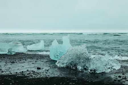 Splinters of ice from Iceberg lagoon jokulsarlon on the sea coast at the south of Iceland. Toned.