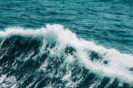 White crest of a sea wave. Selective focus. Shallow depth of field. Toned.の写真素材