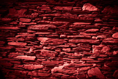 Detail of a wall of an ancient stone house. Red. Toned.の写真素材
