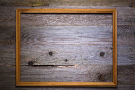 Frame on a wooden rustic texture for background. Rough weathered wooden board. Toned.の写真素材