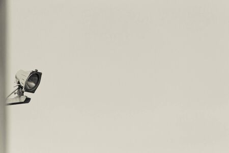 Red waterproof lamp on a blue sky background. Toned.の写真素材