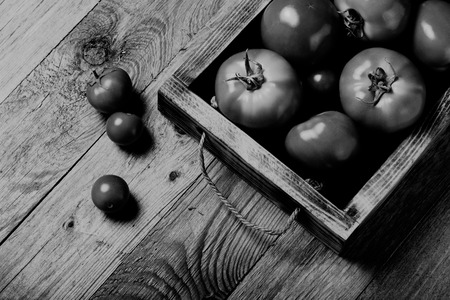 Fresh vegetables on a wooden burned rustic texture for background. Rough weathered wooden board. Toned.の写真素材