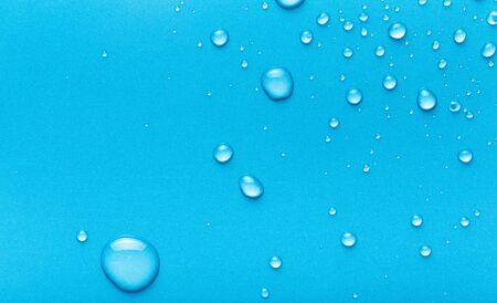 Drops of water on a color background. Blue. Toned.の写真素材