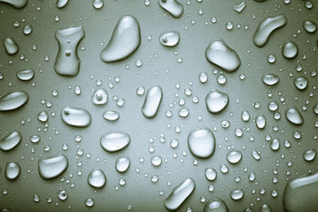 Drops of water on a color background. Gray. Toned.