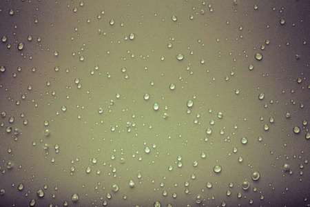 Drops of water on a color background. Gray. Toned.の写真素材