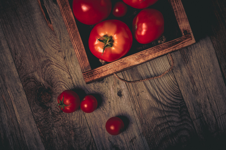 Fresh vegetables on a wooden burned rustic texture for background. Rough weathered wooden board. Toned.の写真素材