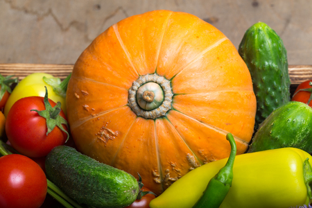 Fresh vegetables and herbs on a wooden burned rustic texture for background. Rough weathered wooden board.の写真素材