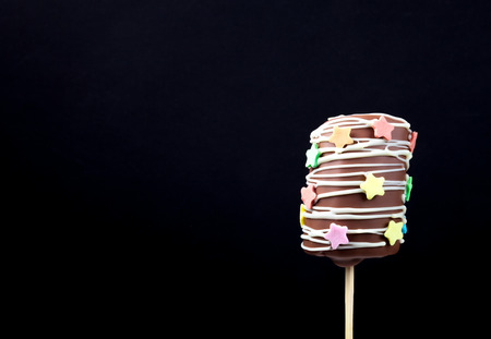 Homemade tiny desserts - banana in chocolate for children's birthday on a dark background.の写真素材
