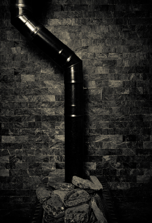 Copper chimney on gray color wall of natural stone. Background texture. Toned.の写真素材