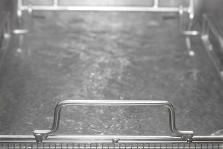 Metal steam table with hot water. Shallow depth of field. Selective focus.