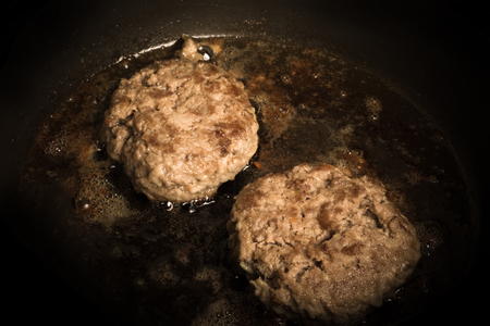 Cutlet fried in oil in a frying pan. Selective focus. Toned.の写真素材