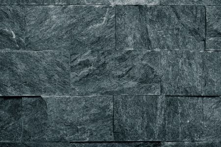 Decorative grey stone wall texture for background. Toned.