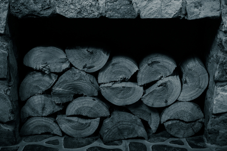 Chopped firewood stacked in a fireplace. Selective focus. Toned.の写真素材