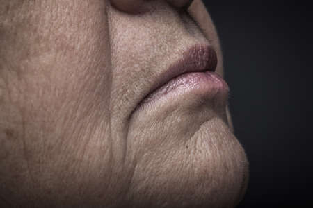 Studio portrait of elderly woman. Profile. Close up detail. Toned.の写真素材