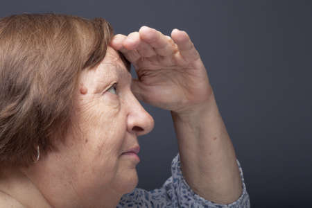 Studio portrait of elderly woman. Profile. Toned.の写真素材