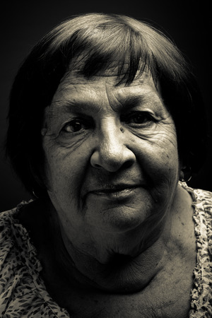 Studio portrait of elderly woman. Smile. Toned.