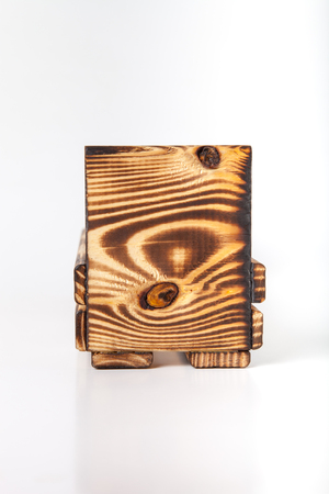 Handmade burned wooden box on a light background.の写真素材