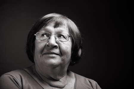 Studio portrait of elderly woman. Smile. Toned.