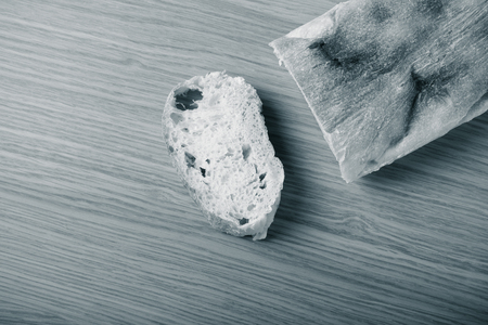 Fresh bread on wooden cutting board. Toned.