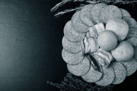 Sausage and bread on a dark  table. Shallow depth of field. Selective focus. Toned.の写真素材