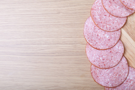 Sausage on a light wooden table. Shallow depth of field. Selective focus.の写真素材