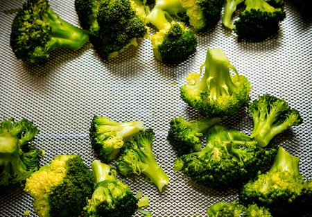 Fresh cauliflower on a metal table of restaurant kitchen. Selective focus. Shallow depth of field....