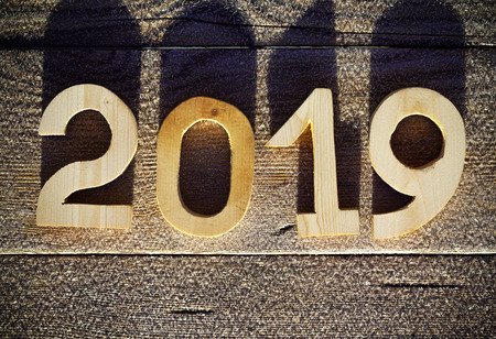 Wooden number 2019 on wooden background. Happy new Year 2019.の写真素材