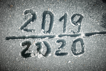 The inscription 2019 and 2020 on the glass by hoarfrost.の写真素材
