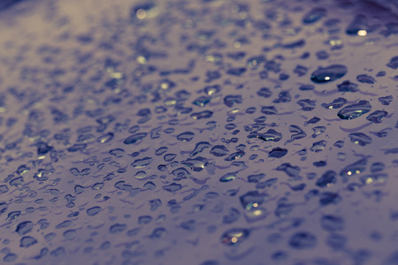 Drops of water on a metal surface for  background. Selective focus.  Shallow depth of field. Toned.の写真素材