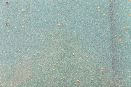Frost on colored glass for a natural winter background.