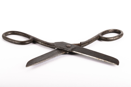 Old metal scissors on a light background.の写真素材