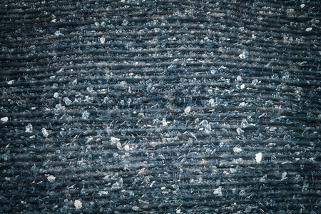 Frost on a old wooden surface. Winter morning dew and freezing. Toned.