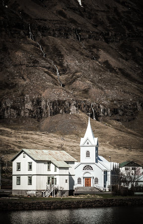 White church in a small village in the fjords of Iceland. Toned.の写真素材