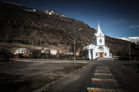 White church in a small village in the fjords of Iceland. Toned.の写真素材