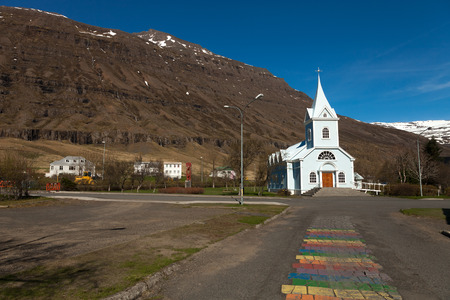 White church in a small village in the fjords of Iceland.の写真素材