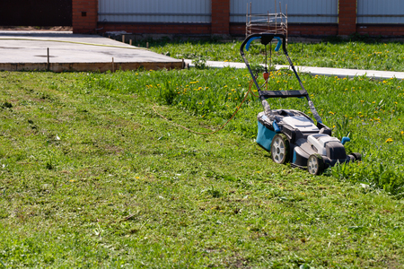 Lawn mower in the spring garden.の写真素材