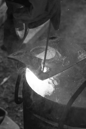 An experienced welder at work. Preparation and welding process of cast iron furnace. Selection...