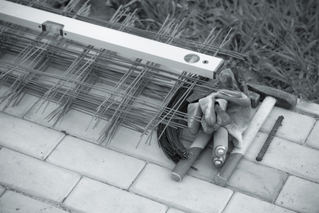 Metal mesh and working tools on the cement tiles.
