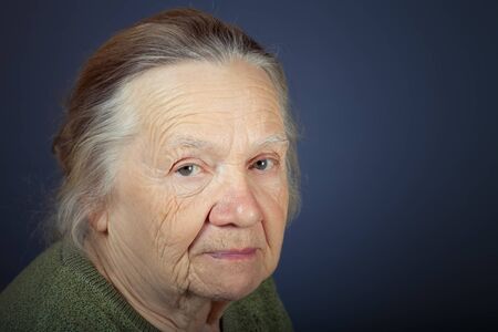Portrait of elderly woman. Attention. Toned.