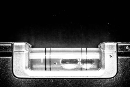 Detail of bubble level on a black background. Toned.