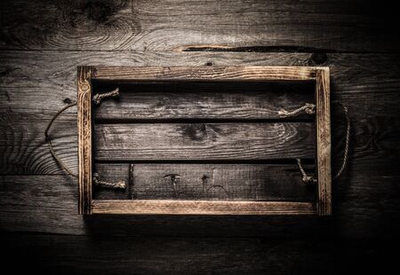 Handmade burned box on a wooden rustic texture for background. Rough weathered wooden board. Toned.の写真素材