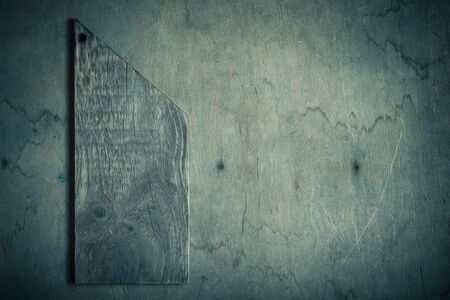 Handmade burned cutting board on a wooden rustic texture for background. Rough weathered wooden...