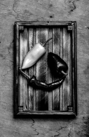Fresh vegetables in a burned rustic texture box for background. Rough weathered wooden board. Toned.の写真素材