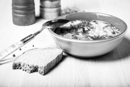 Homemade soup with noodles and meatballs on a wooden table. Traditional rural dinner. Toned.の写真素材