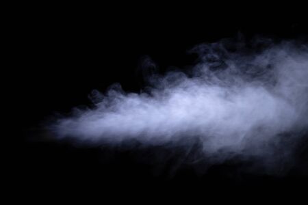 Jet of smoke on black background. Selective focus. Toned.の写真素材