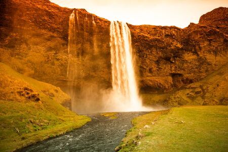 Famous Iceland waterfalls with a clean water on a stony rocky mountain landscape. Toned.
