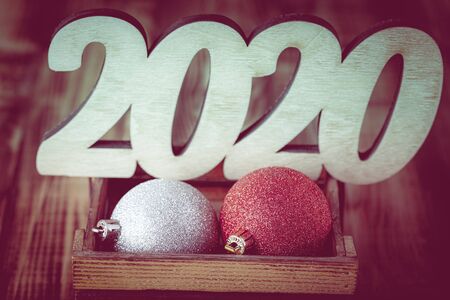 New year composition with wooden figures 2020. Toned.